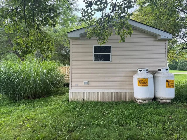 a view of a back yard of the house and car parked