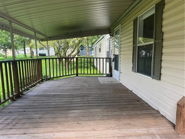 a view of a balcony with wooden floor