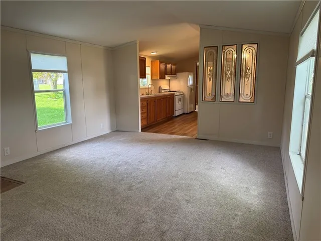 an empty room with windows and cabinet