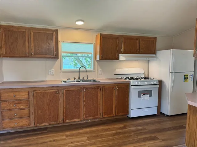 a kitchen with stainless steel appliances white cabinets and a refrigerator