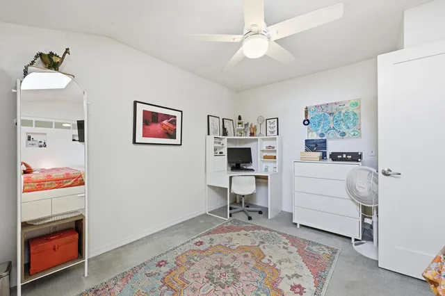 a front view of a house with plants