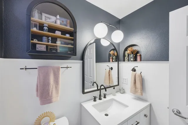 a bathroom with a double vanity sink mirror and