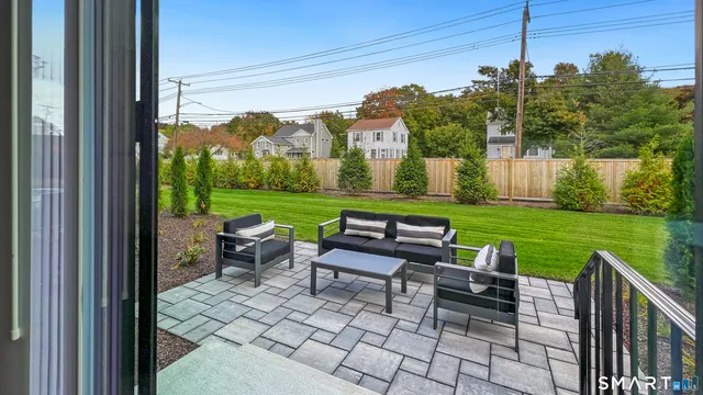 a view of a chairs and table in patio with a yard