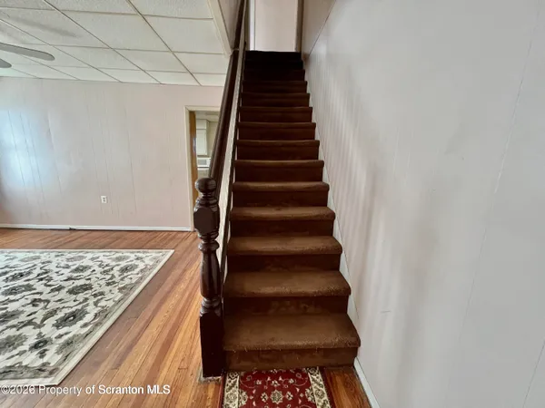 a view of an empty room and wooden floor