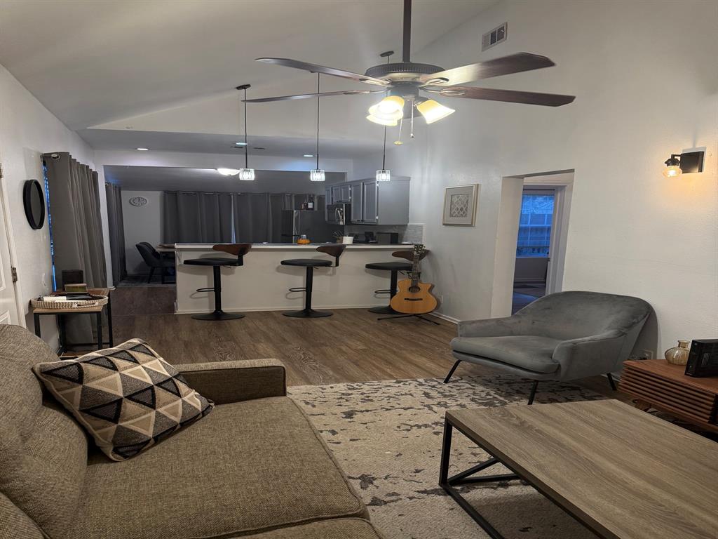 4347 Travis Street, Unit 4347 Dallas, TX 75205 - Photo 2 of 12 a living room with furniture and a chandelier