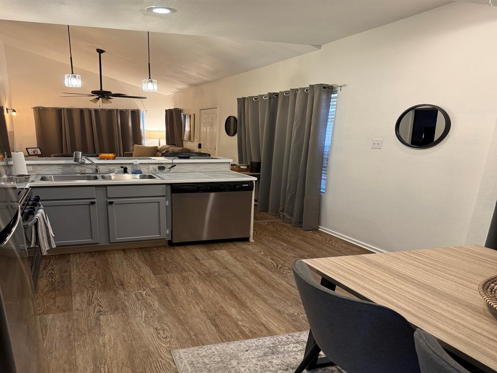 4347 Travis Street, Unit 4347 Dallas, TX 75205 - Photo 3 of 12 a kitchen with stainless steel appliances granite countertop a sink and a refrigerator