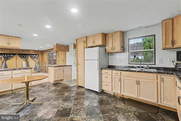 a kitchen with white cabinets and refrigerator