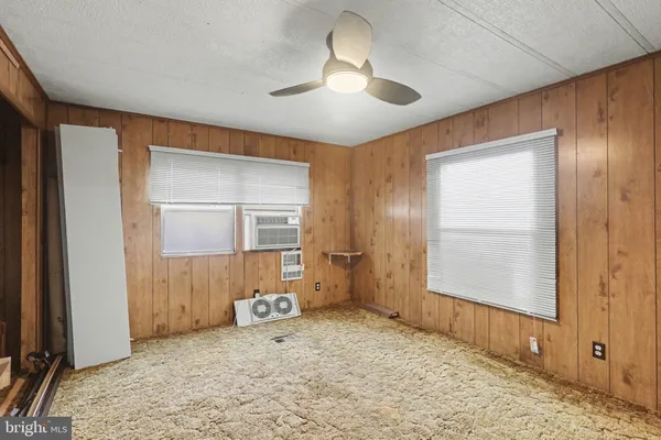 a view of a room with a wardrobe space and wooden floor