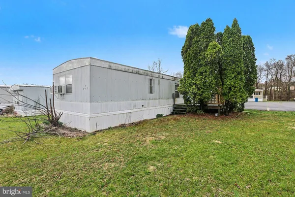 a view of a tiny house with a yard