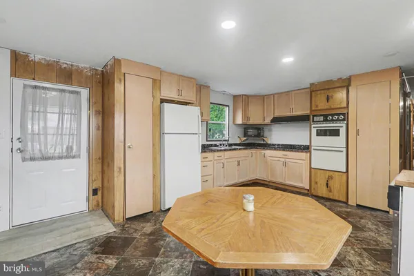 a kitchen with a refrigerator sink and cabinets