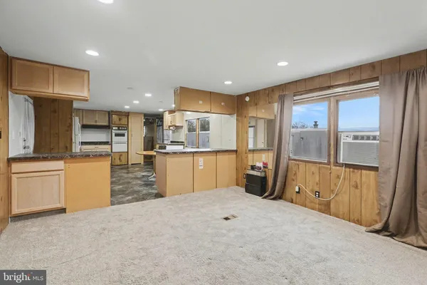 a kitchen with refrigerator a sink and wooden cabinets