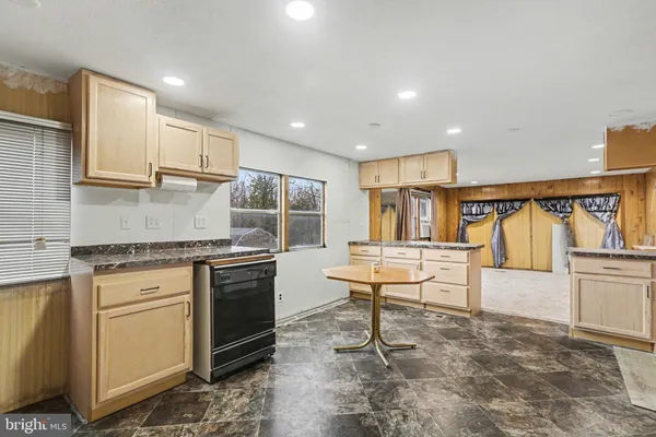 a kitchen with stainless steel appliances granite countertop a stove and a sink