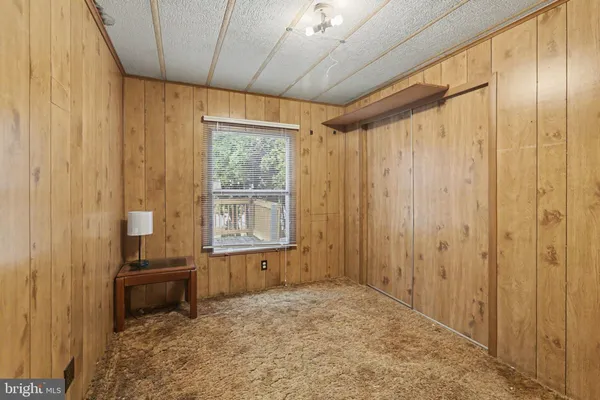 a view of a room with a flat screen tv and windows