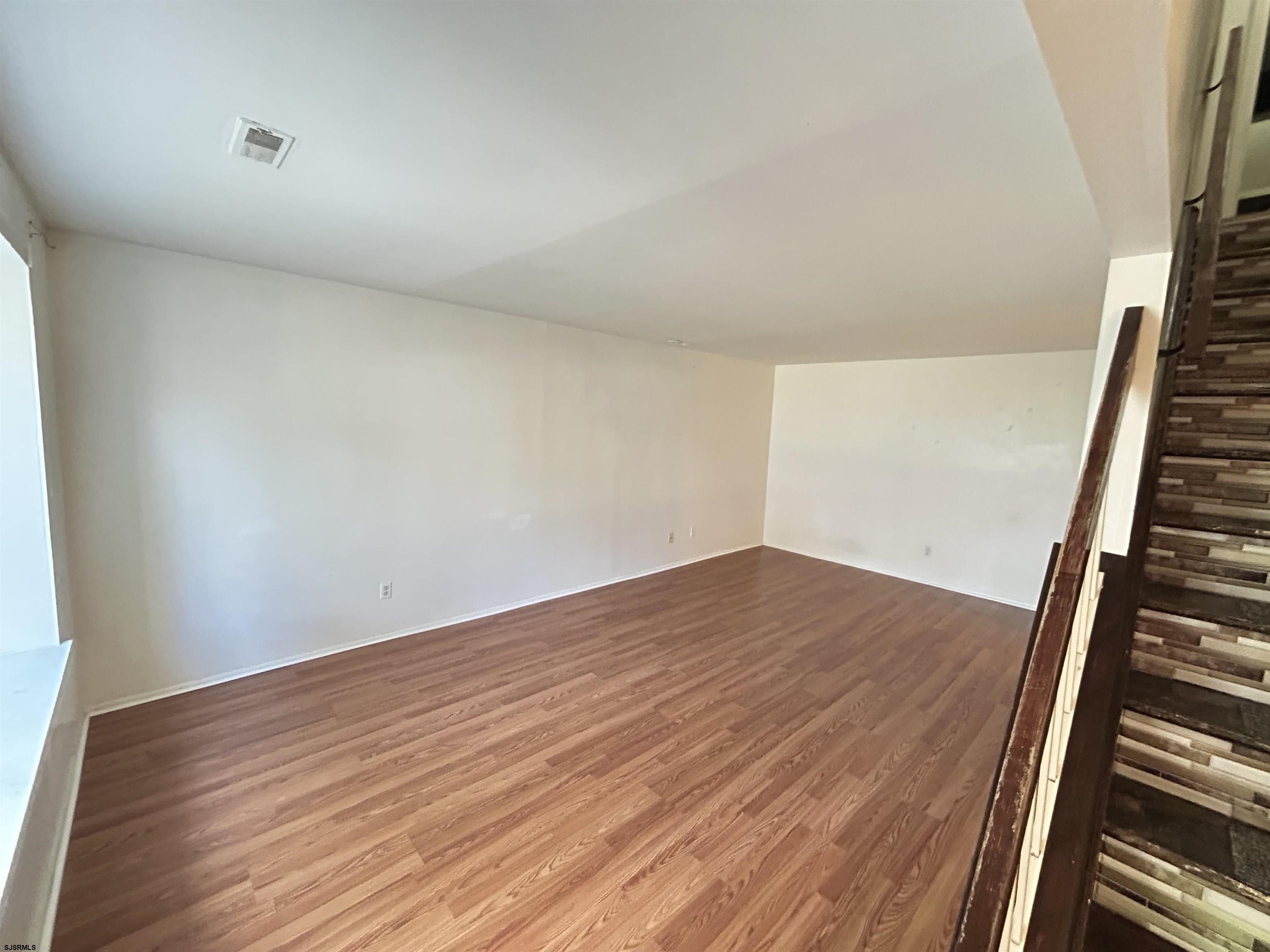 2465 Arbor Court, Unit 2465 Mays Landing, NJ 08330 - Photo 2 of 10 a view of an empty room with wooden floor