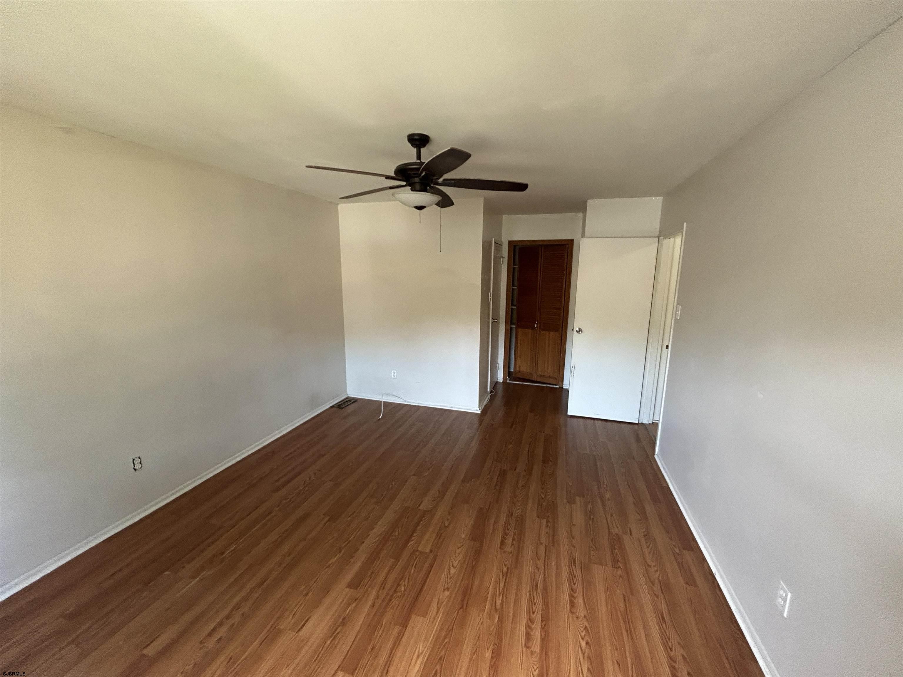 2465 Arbor Court, Unit 2465 Mays Landing, NJ 08330 - Photo 8 of 10 a view of empty room with wooden floor and fan