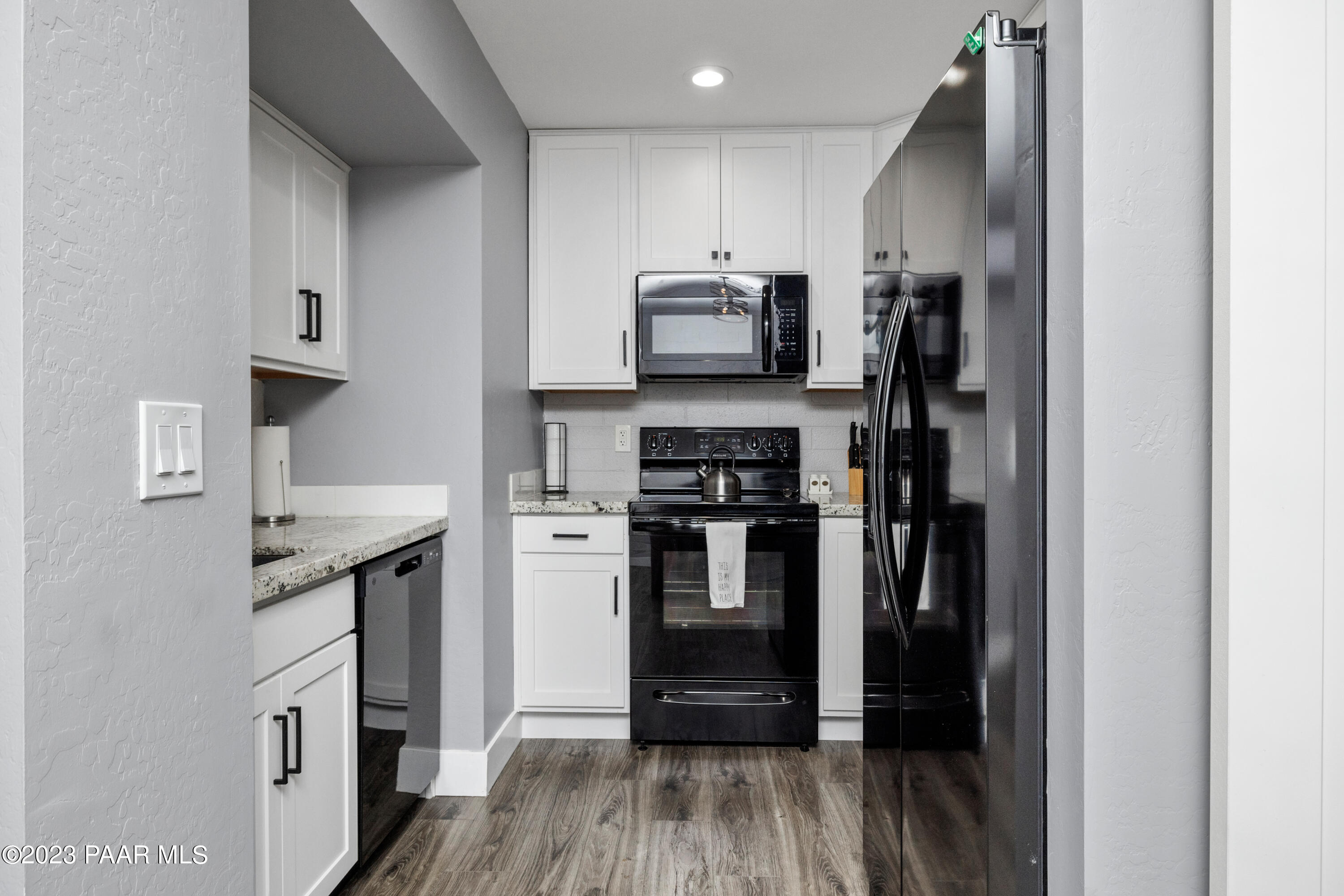 8339 Florentine Road, Unit 6 Prescott Valley, AZ 86314 - Photo 5 of 21 a kitchen with stainless steel appliances a refrigerator stove and microwave