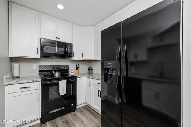 a kitchen with a refrigerator stove and microwave