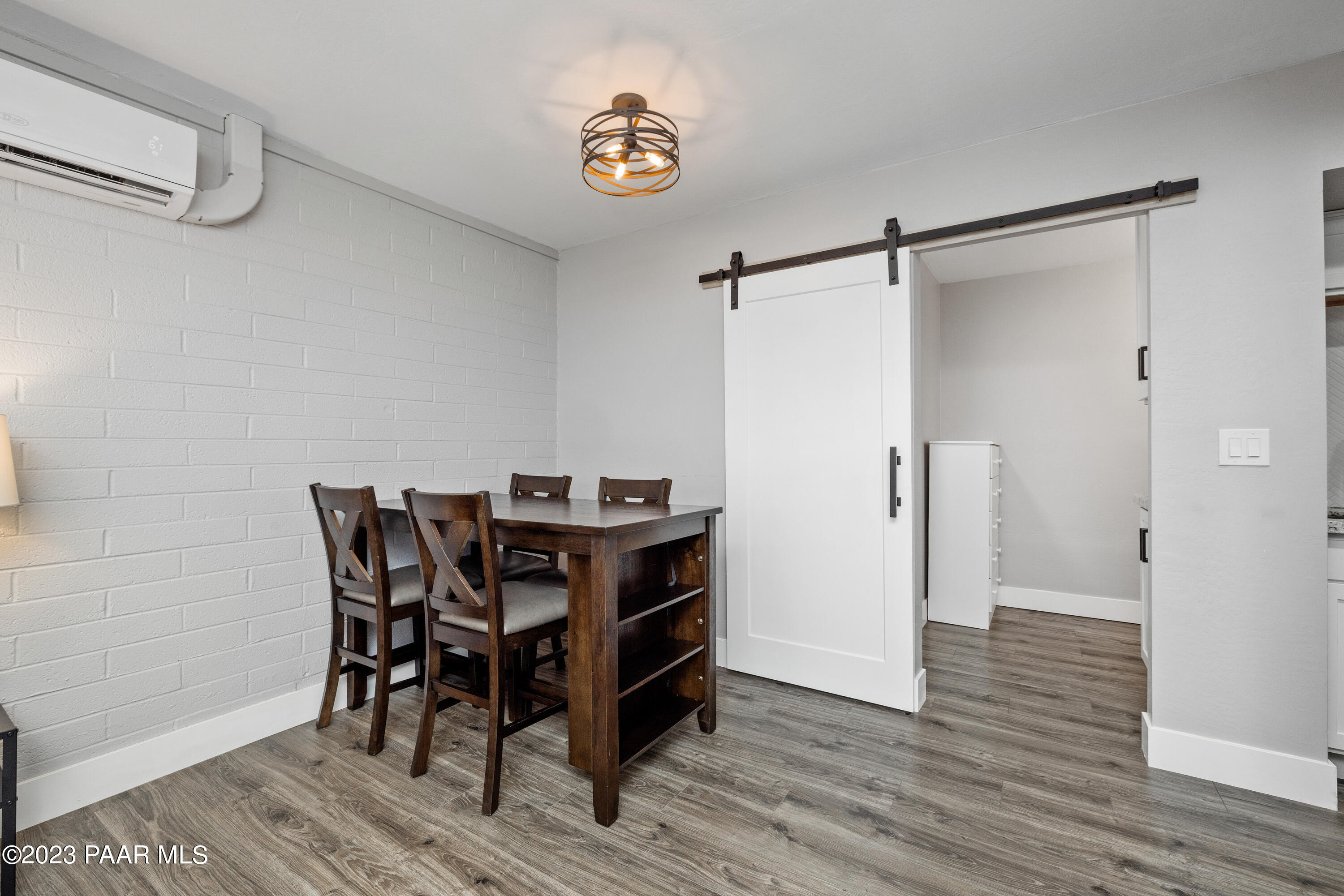 8339 Florentine Road, Unit 6 Prescott Valley, AZ 86314 - Photo 10 of 21 a view of a dining room with hardwood floor and a ceiling fan