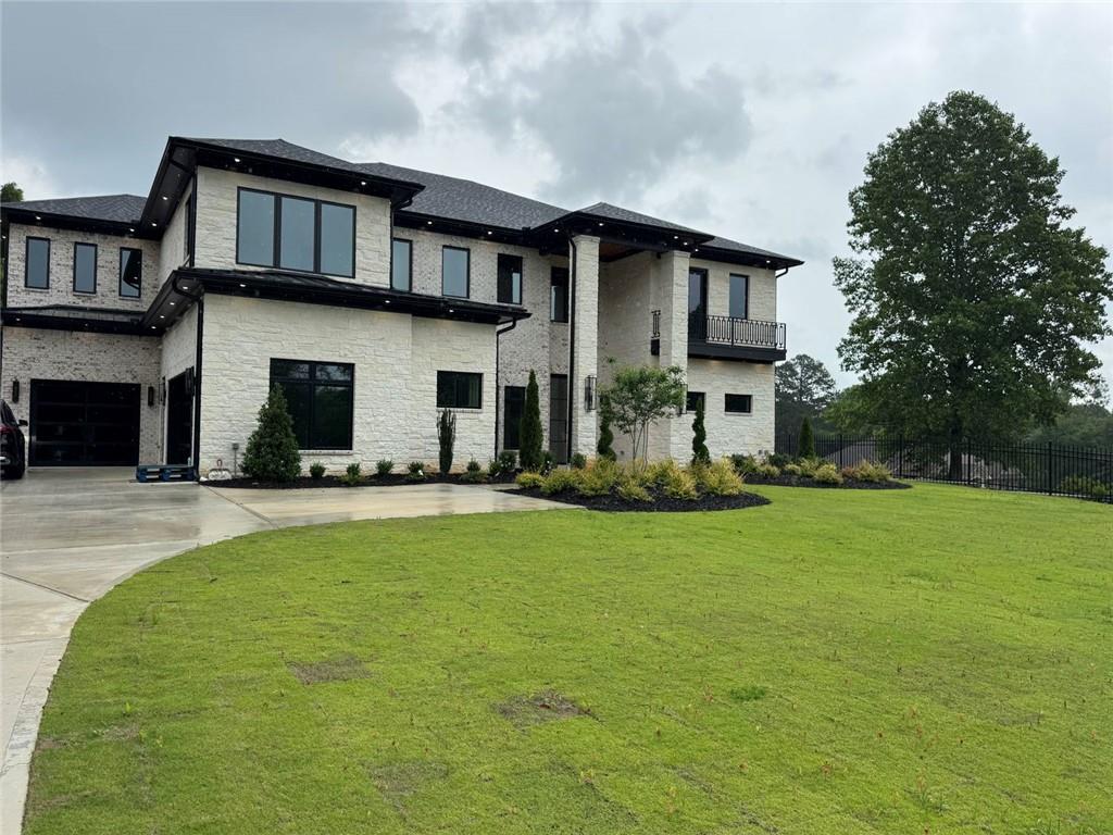 3425 Thompson Mill Road Buford, GA 30519 - Photo 5 of 48 a front view of a house with a yard