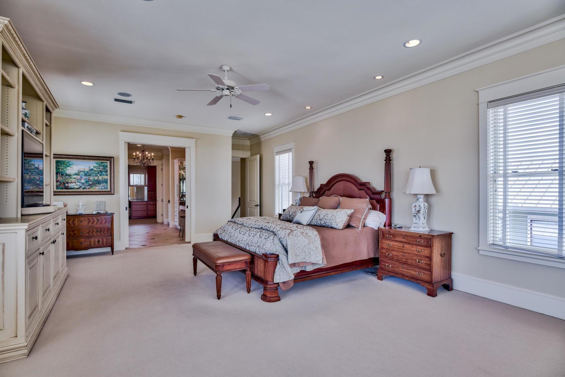 216 Sandtrap Road Miramar Beach, FL 32550 - Photo 30 of 58 a spacious bedroom with a bed and a chandelier