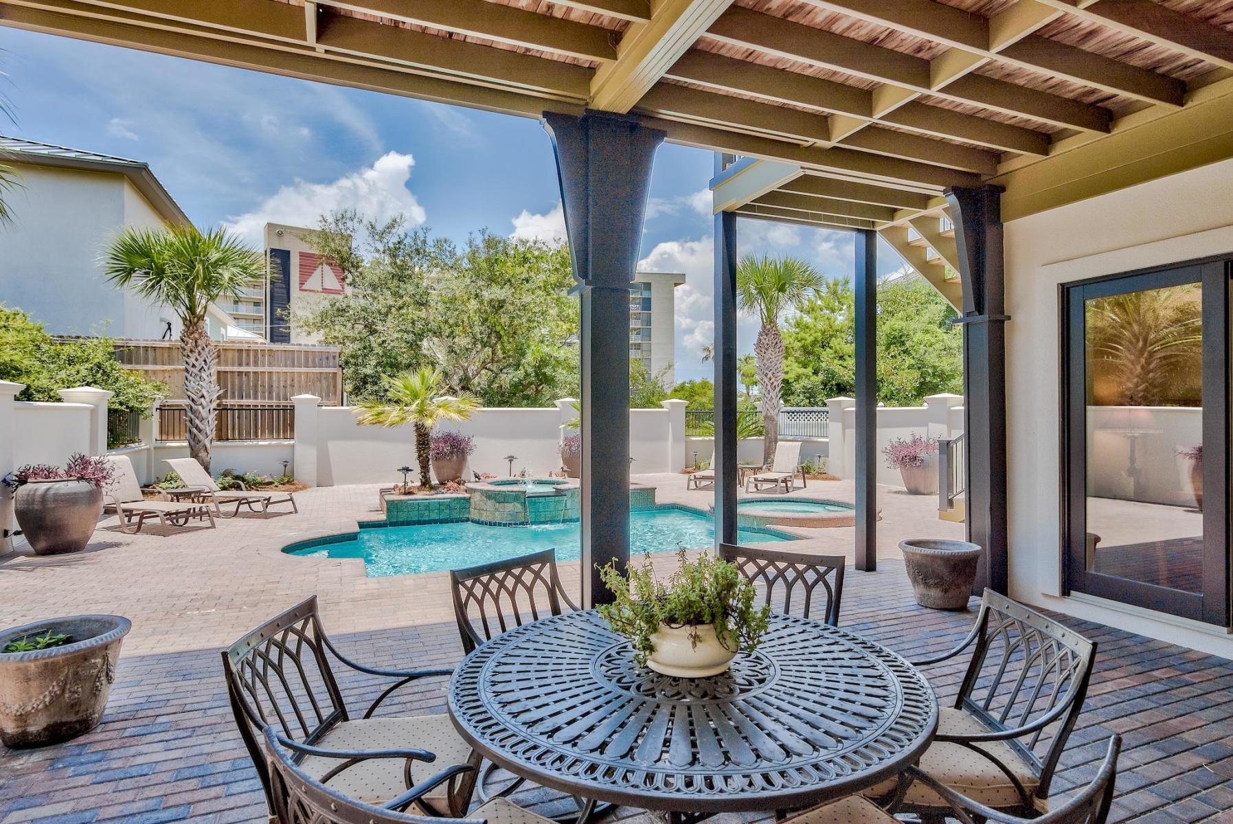 216 Sandtrap Road Miramar Beach, FL 32550 - Photo 46 of 58 a view of a patio with a dining table and chairs