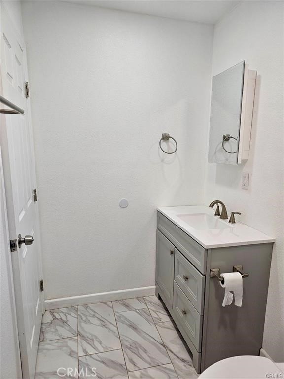 769 East 7th Street, Unit B Upland, CA 91786 - Photo 9 of 12 a bathroom with a sink a toilet and mirror