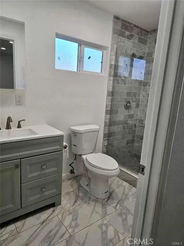 a bathroom with a toilet and shower