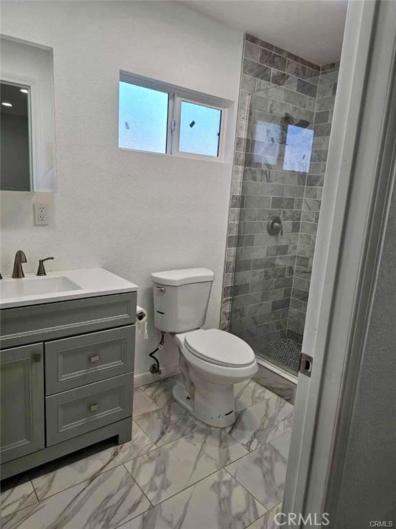 769 East 7th Street, Unit B Upland, CA 91786 - Photo 10 of 12 a bathroom with a toilet sink and a shower
