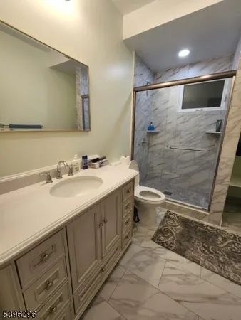 a bathroom with a double vanity sink toilet and shower