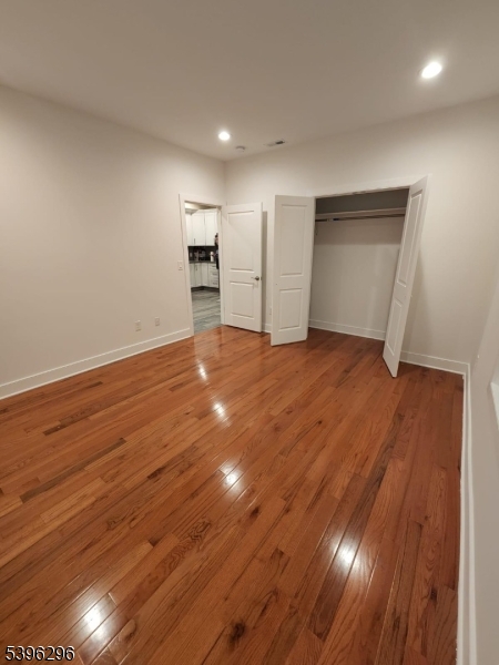 229 East 24th Street Paterson, NJ 07514 - Photo 4 of 15 a view of empty room with wooden floor