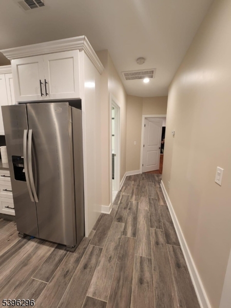 229 East 24th Street Paterson, NJ 07514 - Photo 7 of 15 a view of a refrigerator in kitchen and an empty room