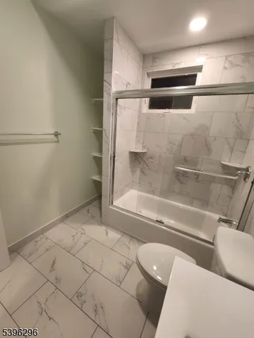 a bathroom with a bathtub and toilet