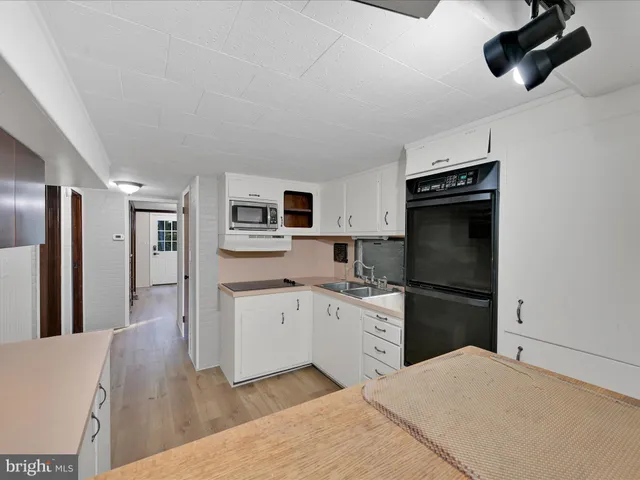 a kitchen with stainless steel appliances a refrigerator stove microwave and cabinets