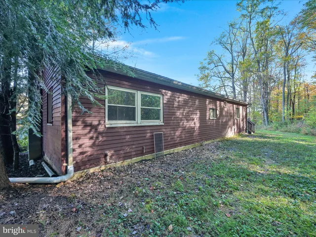 a view of brick house with a yard
