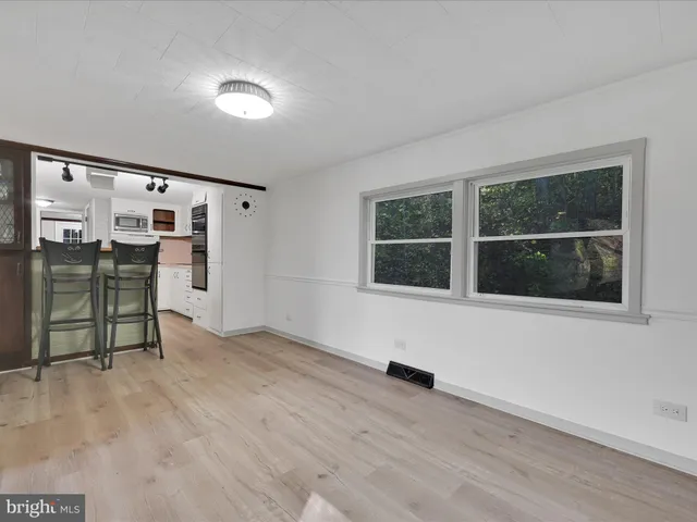 an empty room with windows and closet