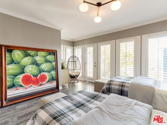 a bedroom with a bed mirror and window