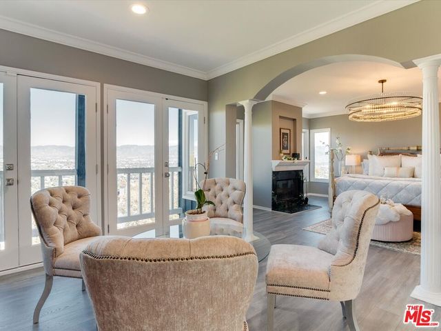 a living room with furniture and large windows