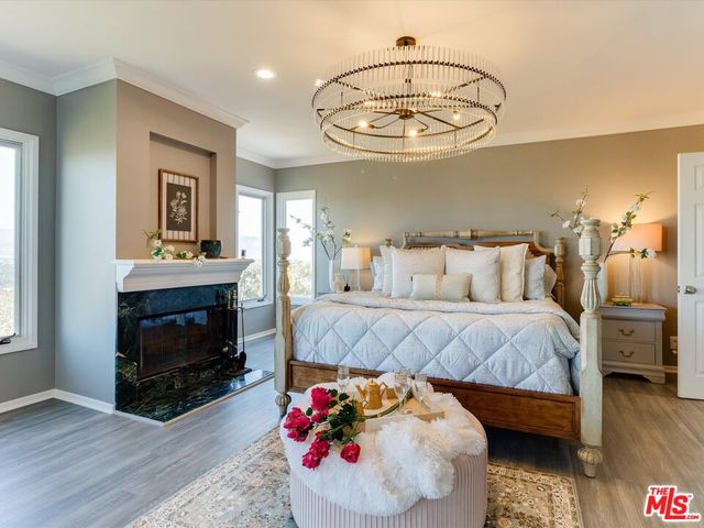 a bedroom with bed and a fireplace