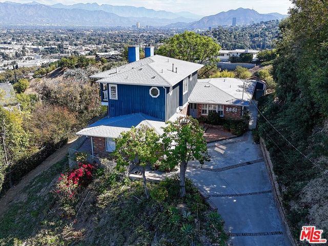 an aerial view of a house with a garden
