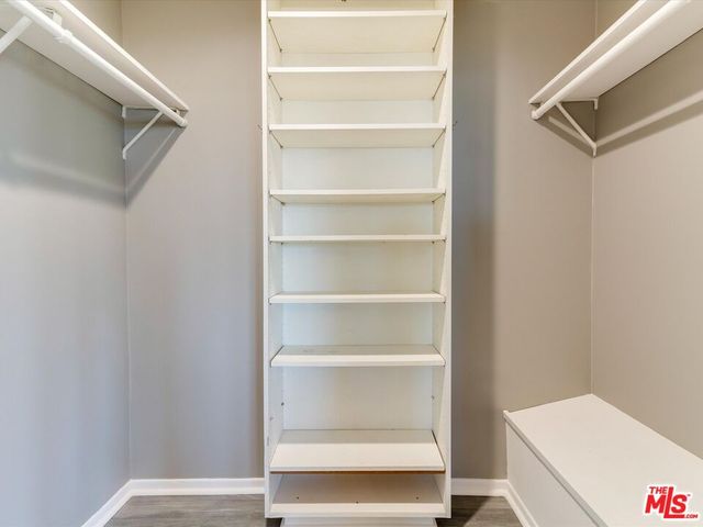 a view of walk in closet with empty racks