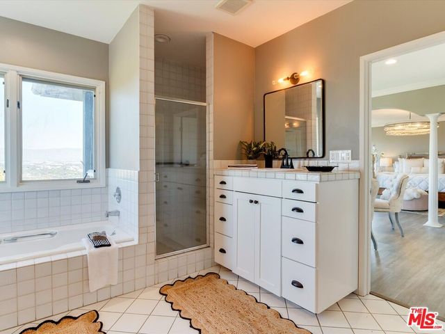 a spacious bathroom with a granite countertop tub sink and mirror