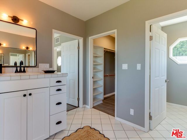 a bathroom with a shower sink and mirror