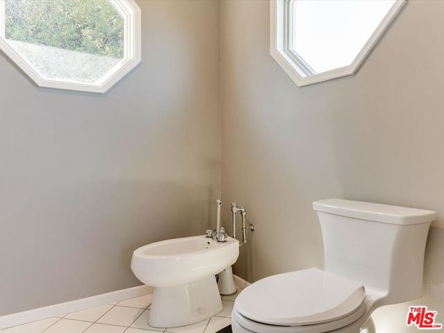 a white toilet sitting next to a white sink