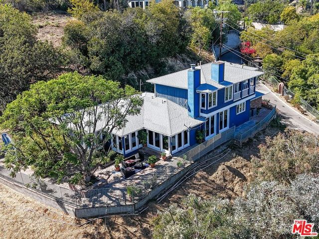 a view of a house with roof deck front of house