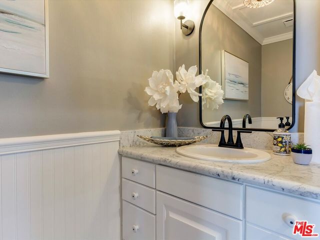 a bathroom with a sink vanity granite and a mirror