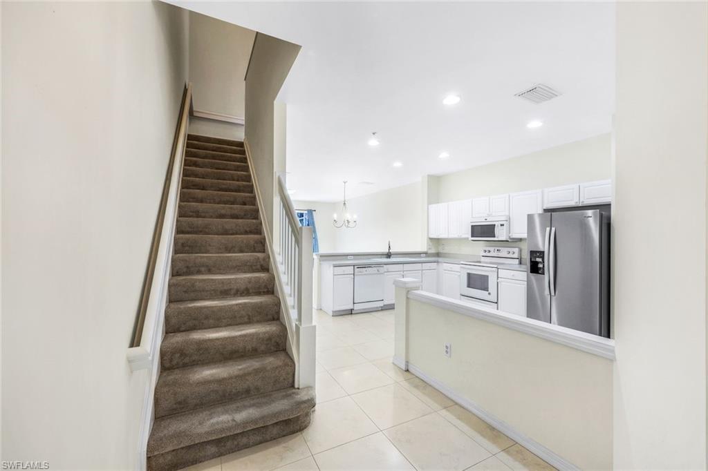 15612 Marcello Circle, Unit 158 Naples, FL 34110 - Photo 3 of 27 a view of kitchen with wooden floor and electronic appliances