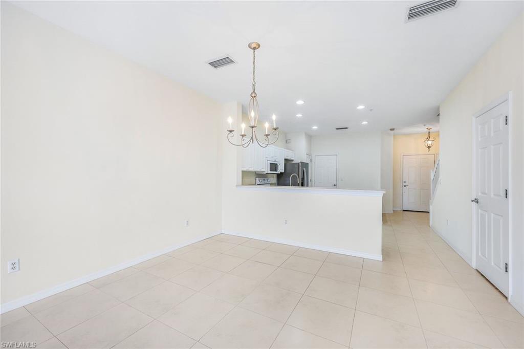15612 Marcello Circle, Unit 158 Naples, FL 34110 - Photo 6 of 27 a view of a kitchen with a sink and chandelier