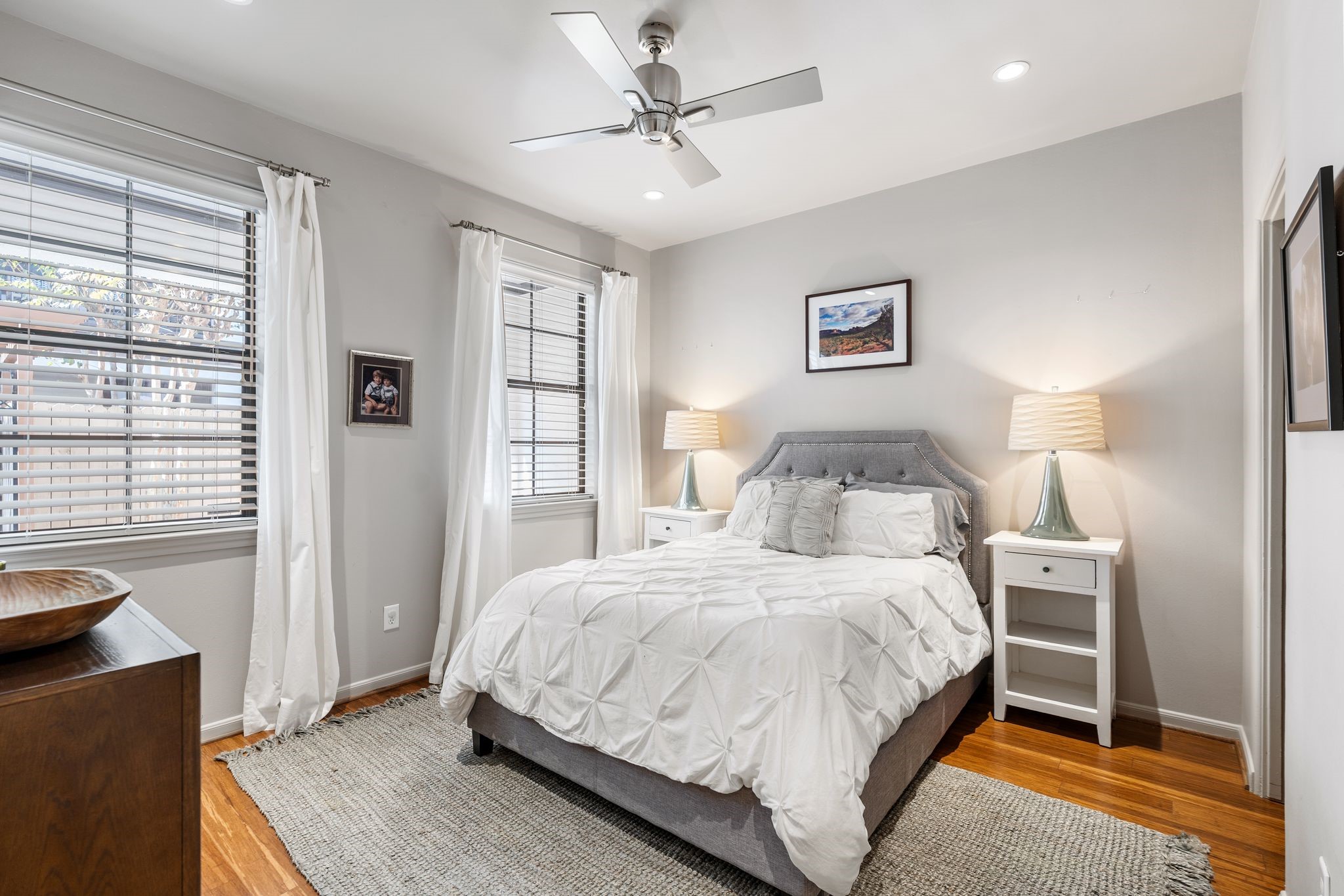 3934 Feagan Street Houston, TX 77007 - Photo 20 of 27 This is the first floor guest bedroom with bamboo hardwood flooring, recessed lighting, and a ceiling fan. Hunter Douglas wood blinds with drapes on the windows, plus a large walk-in closet that extends into under the stair storage.