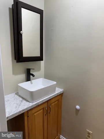 a bathroom with a sink vanity and a mirror
