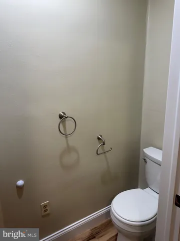 a white toilet and a shower in a bathroom